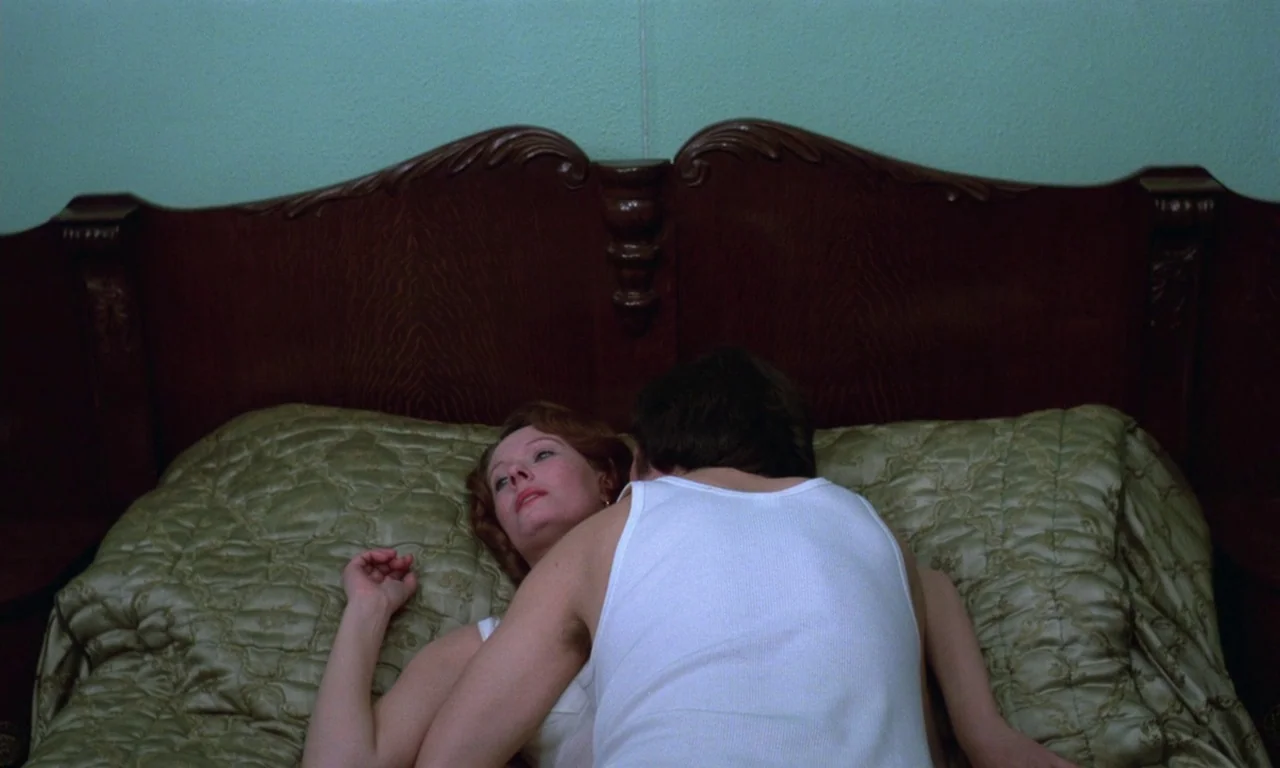 Jeanne Dielman, 23, quai du commerce, 1080 Bruxelles (1975) movie still: medium — A green-walled bedroom features a dark wood headboard against the…