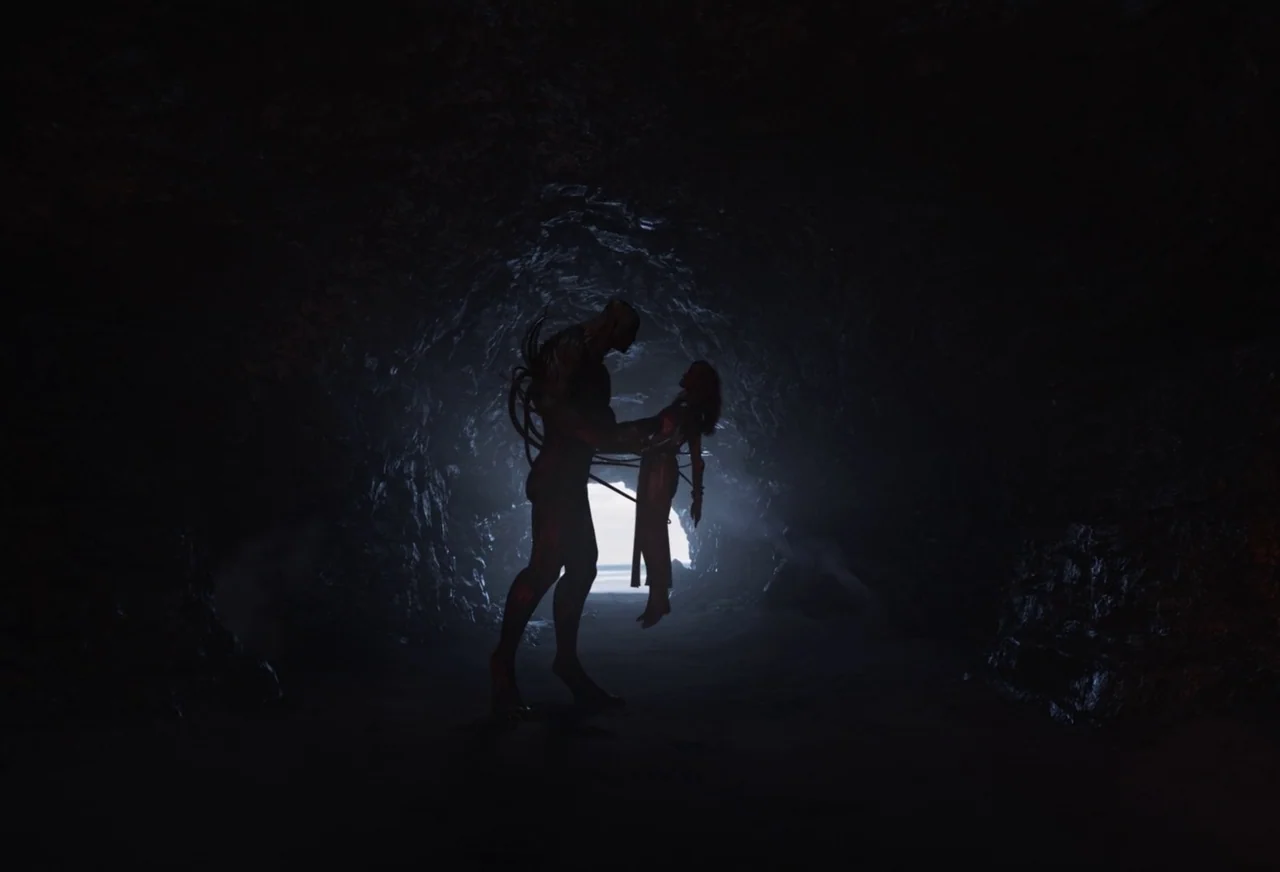 Eternals (2021) movie still: fullbody — A dark, cavernous interior space illuminated by a bright opening in the distant background. A large,…