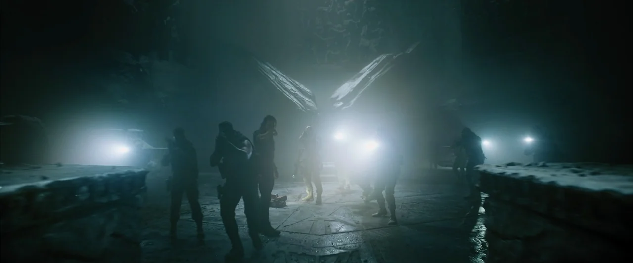 Black Adam (2022) movie still: wide — A dark, cavernous stone hall is filled with dense fog and shadows. A team of soldiers moves through the space…