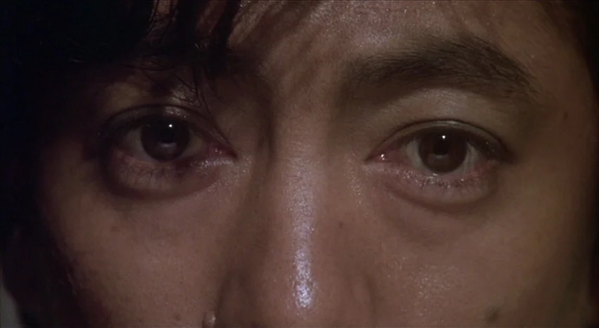 Mishima: A Life in Four Chapters (1985) movie still: closeup — A close-up view of a person's eyes and upper face. The subject faces the camera…