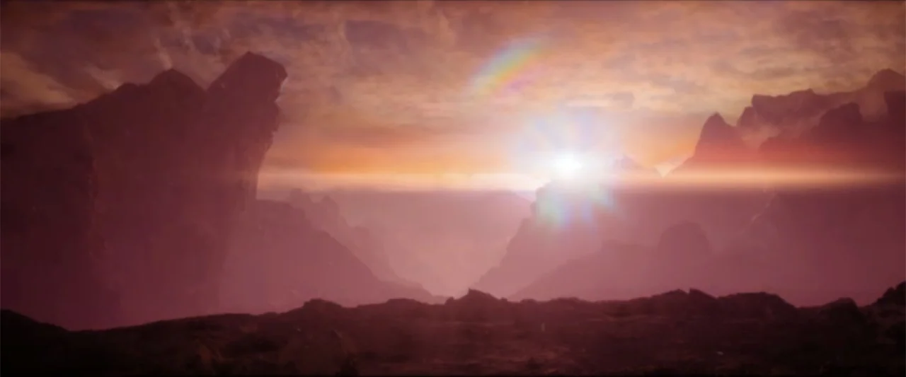 Ash (2025) movie still: establishing — Jagged rock formations rise above a low, flat valley during a sunset. The bright sun sits on the horizon…