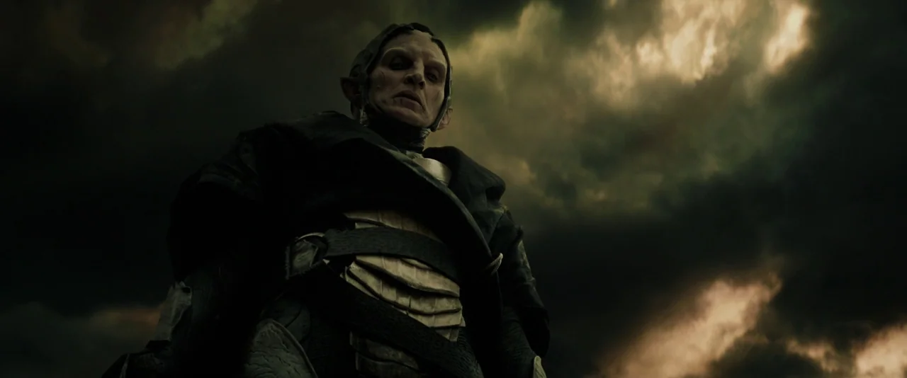 Thor: The Dark World (2013) movie still: medium — A dark, ominous sky with heavy storm clouds looms behind a fantasy-themed figure. The figure wears…