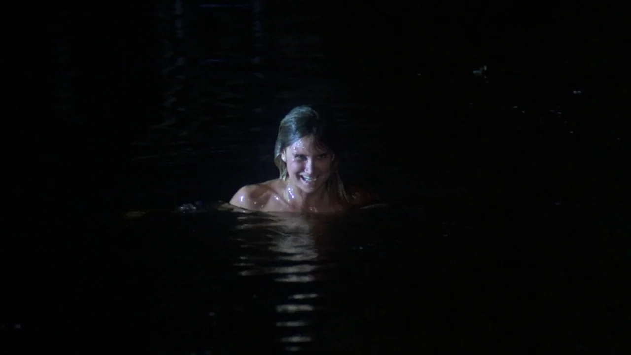 Friday the 13th Part VII: The New Blood (1988) movie still: medium — A woman is swimming in dark open water during the nighttime. The subject is…