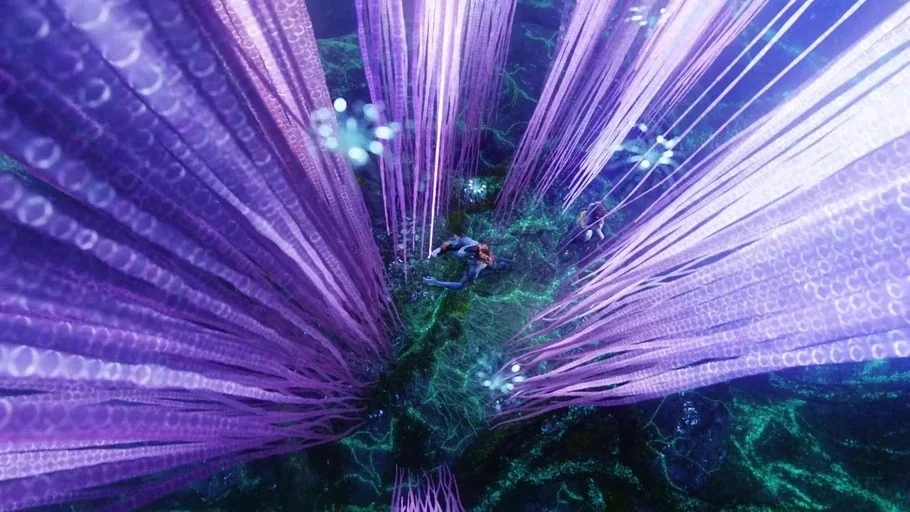 Avatar (2009) movie still: wide — A dense alien jungle floor is covered with bioluminescent root systems and purple tentacles. Two figures rest on…