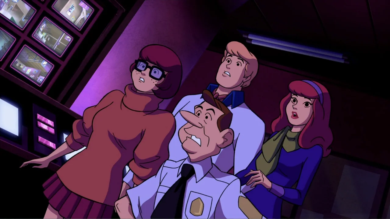 Scooby-Doo! Mask of the Blue Falcon (2012) movie still: medium — A dark security room filled with glowing wall-mounted television monitors showing…