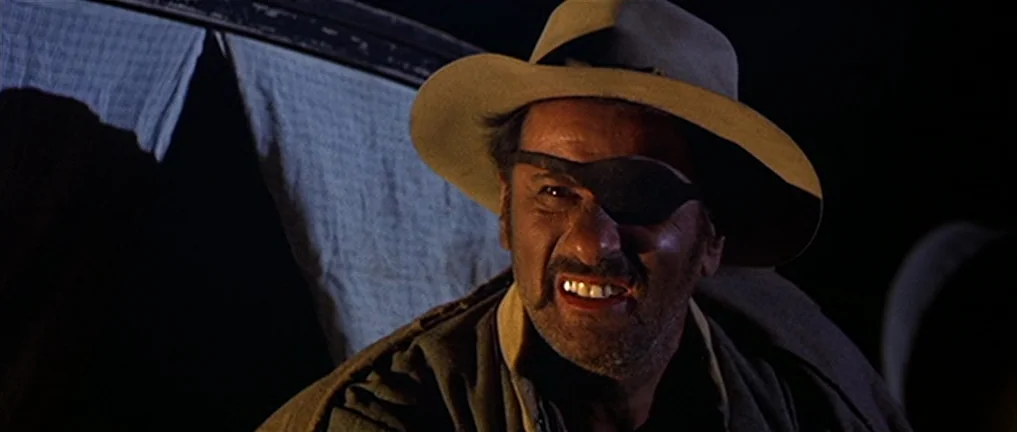 The Good, The Bad And The Ugly (1966) movie still: closeup — A dark night setting featuring the interior or side of a horse-drawn wagon. A…