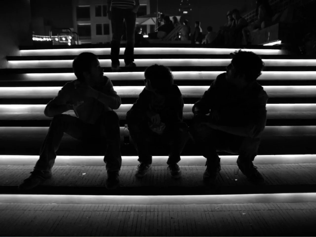 Güeros (2014) movie still: medium — A concrete outdoor staircase is illuminated by horizontal LED strips built into the steps. Three people sit on…