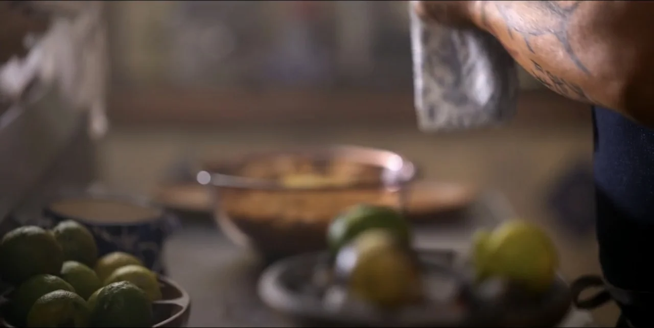 El sabor de la Navidad (2023) movie still: closeup — A domestic kitchen counter holds bowls of green limes and ingredients under natural light. A…