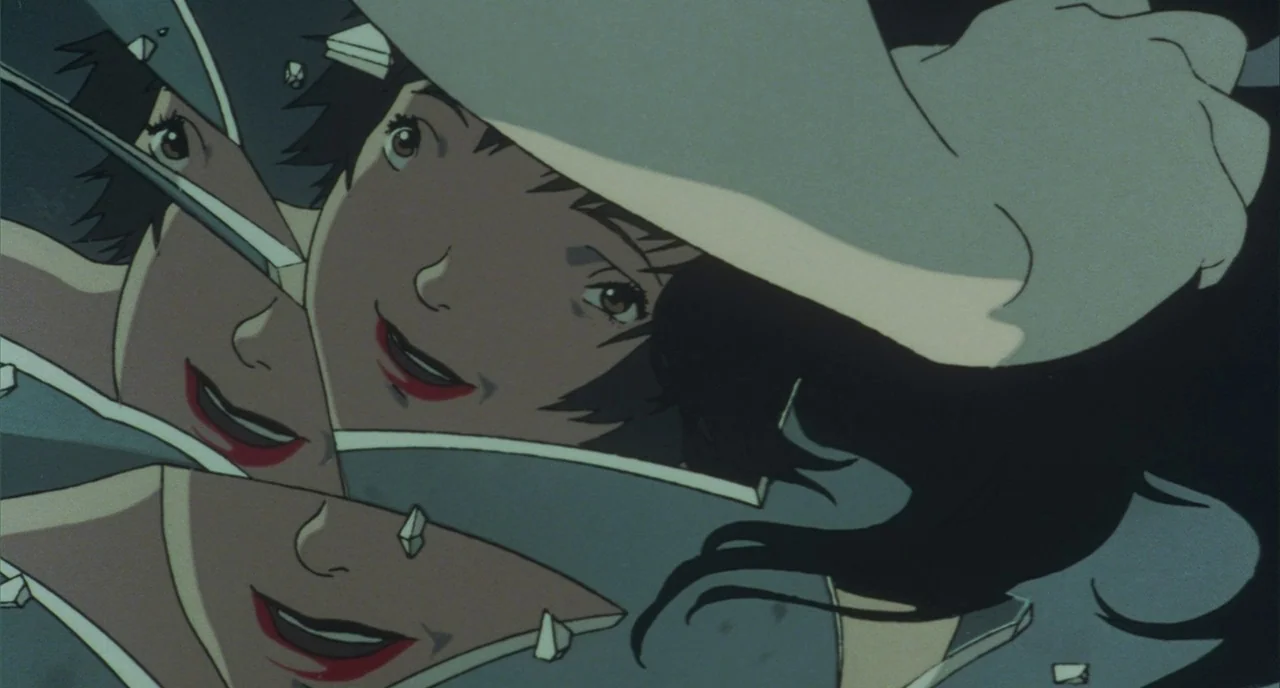 Perfect Blue (1997) movie still: closeup — A dark void filled with shattered mirror shards reflecting a human face. The face is fragmented across…