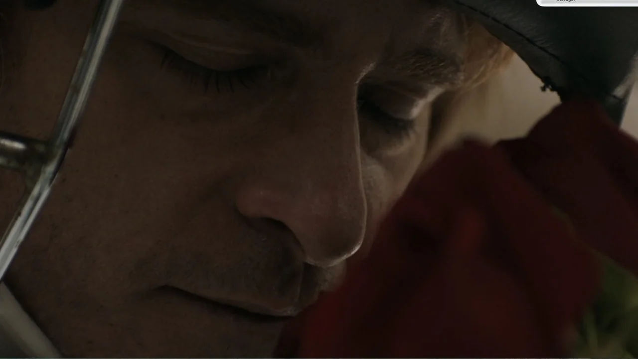 Don't Worry, He Won't Get Far on Foot (2018) movie still: closeup — A dimly lit room provides the backdrop for a close portrait of a man. The man…