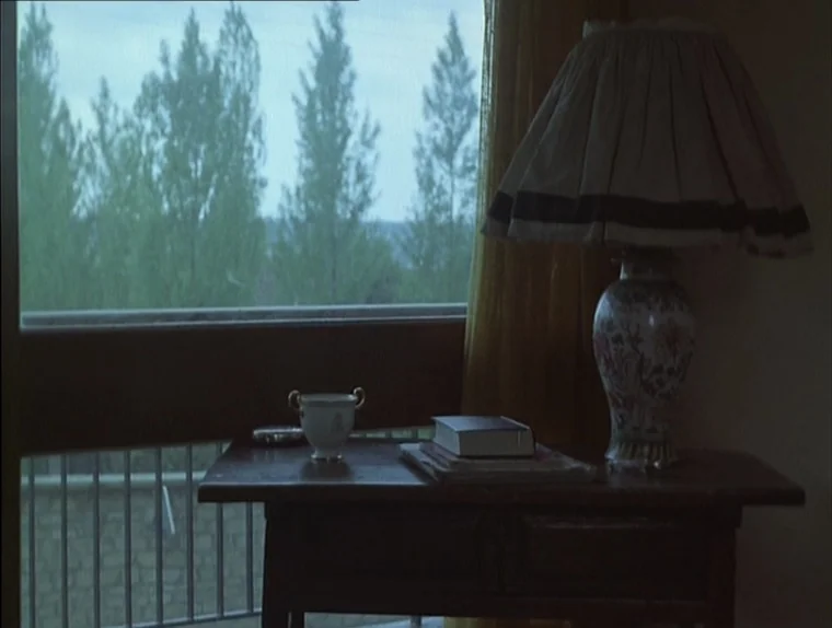 Love In The Afternoon (Chloe In The Afternoon) (L’amour l’après-midi) (1972) movie still: medium — A wooden table sits in front of a window…