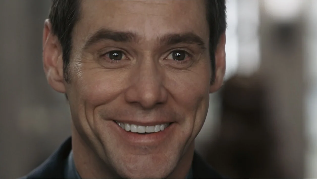 Fun with Dick and Jane (2005) movie still: closeup — An interior office space with blurred neutral walls visible in the soft-focus background. A…