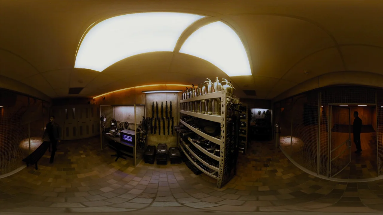 Fahrenheit 451 (2018) (2018) movie still: wide — An industrial storage room contains metal shelving units holding canisters and various equipment…