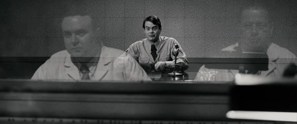 Pineapple Express (2008) movie still: medium — A 1950s broadcast studio features sound-dampening walls and a reflective glass partition. A man in a…