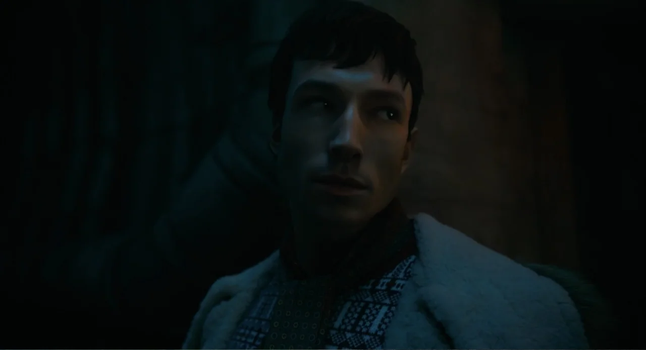 The Flash (2023) movie still: medium — A dimly lit interior space with dark walls obscuring the background. A man in a shearling coat looks toward…