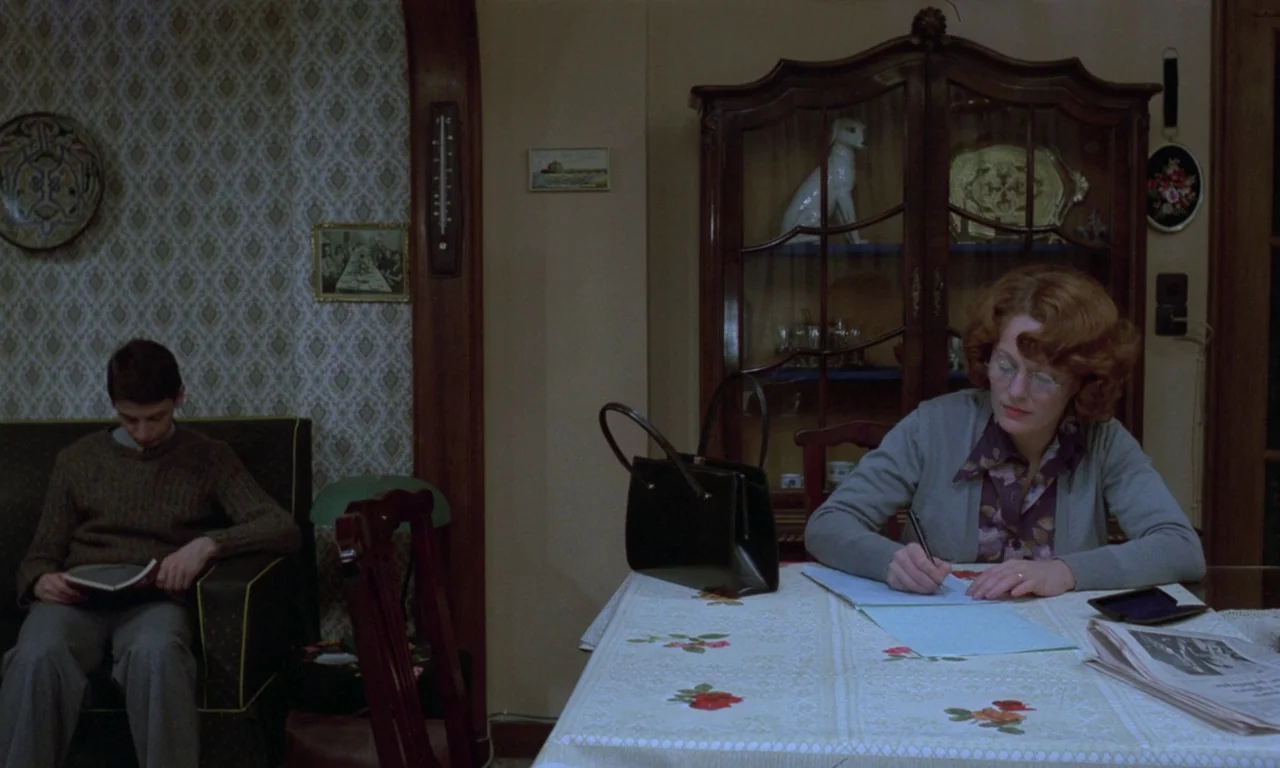 Jeanne Dielman, 23, quai du commerce, 1080 Bruxelles (1975) movie still: medium — A quiet domestic interior with patterned wallpaper, an antique…