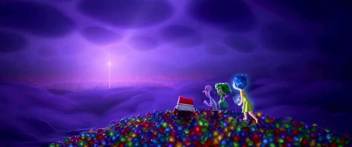 Inside Out 2 (2024) movie still: wide — A pile of multi-colored spheres sits in an abstract purple landscape under cloud-covered skies. Four…