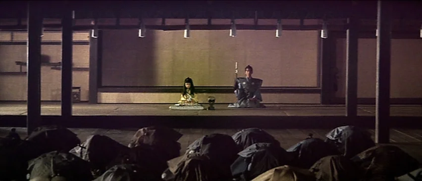 Lone Wolf and Cub: Baby Cart in the Land of Demons (1973) movie still: wide — A spacious wooden hall features a raised dais where two figures sit…