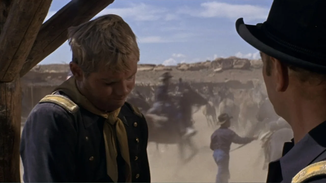A Distant Trumpet (1964) movie still: medium — A dusty military encampment in a desert landscape during the nineteenth century. A young blonde…