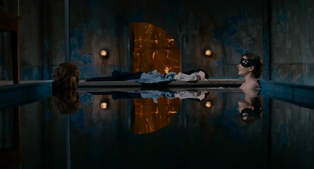 Fur: An Imaginary Portrait Of Diane Arbus (2006) movie still: wide — A dimly lit industrial interior featuring a rectangular pool with dark,…