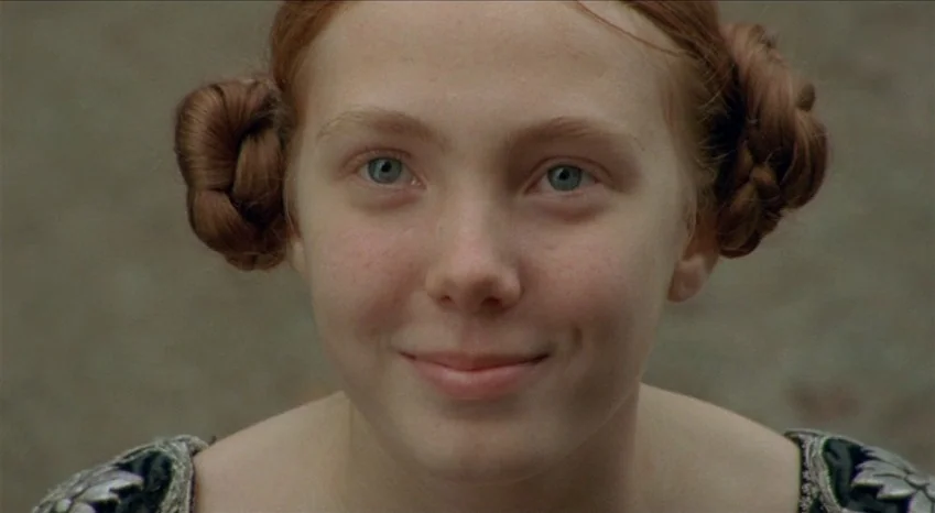Bluebeard (2009) movie still: closeup — A teenage girl stands in an outdoor setting with a soft, neutral ground. She looks forward while wearing a…