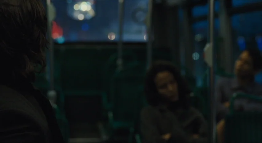 35 Shots of Rum (2008) movie still: medium — The interior of a bus at night features green plastic seating and vertical poles. Several passengers…