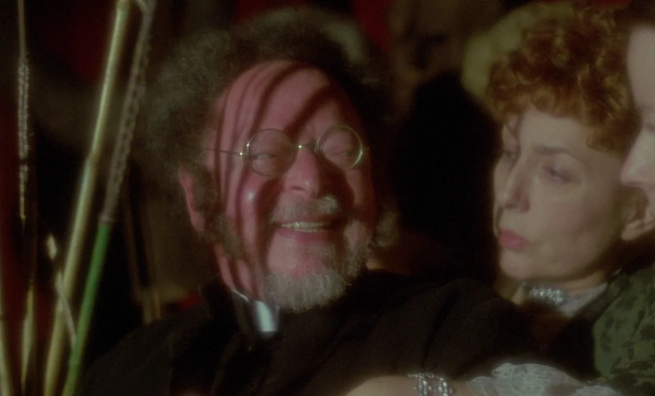 The Strange Case of Dr. Jekyll and Miss Osbourne (1981) movie still: medium — A dimly lit Victorian-era theater interior with patterned walls and…