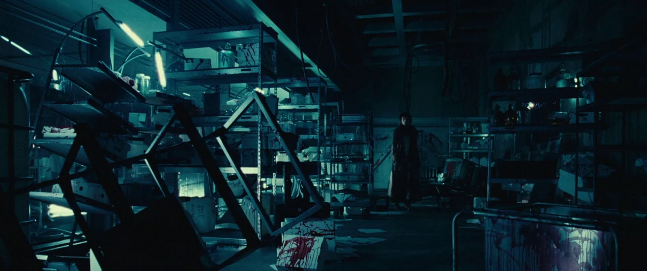 Resident Evil: Extinction (2007) movie still: wide — A dark, ransacked laboratory space features metal shelves scattered with medical supplies and…