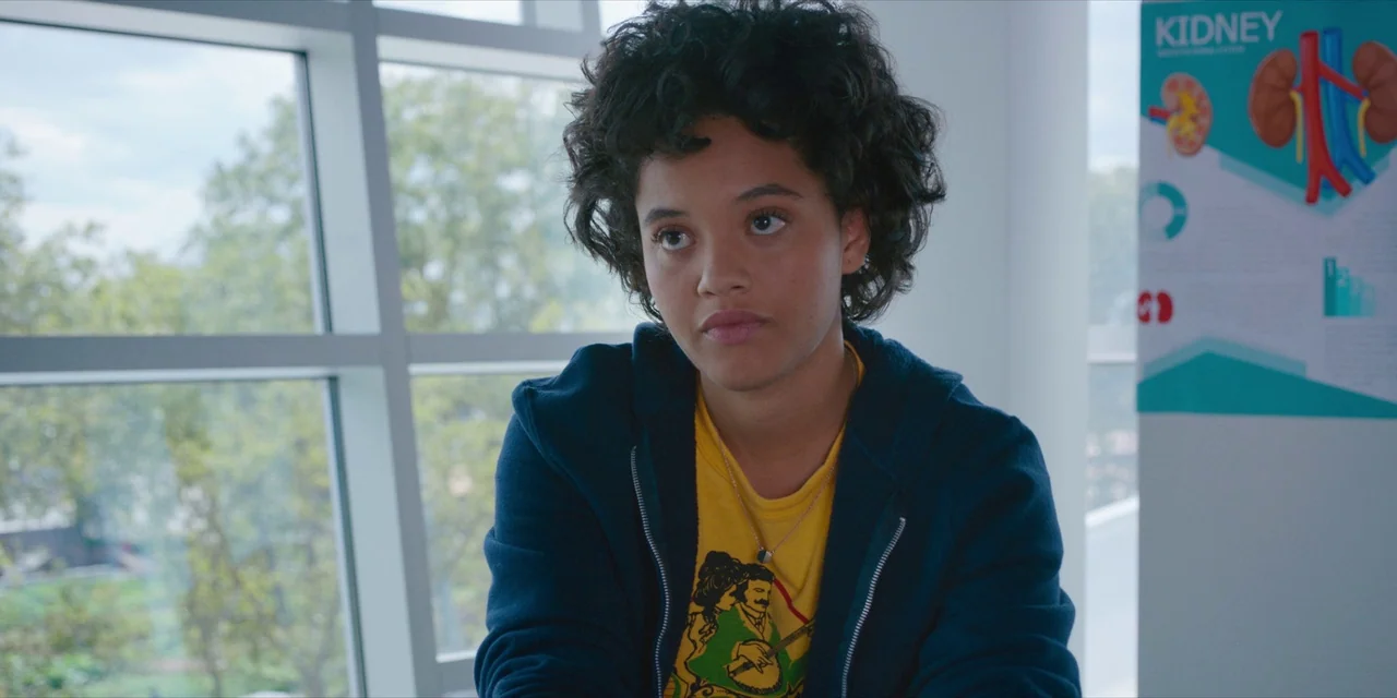 Hearts Beat Loud (2018) movie still: medium — A medical office with a kidney anatomy diagram on the white wall. A teenage girl sits in front of a…