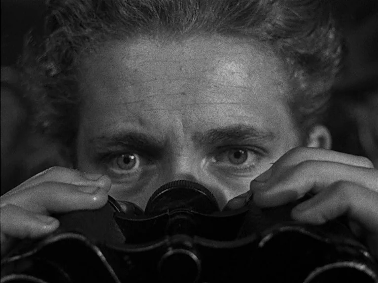The Big Night (1951) movie still: closeup — A man's face fills the frame as he looks directly into binoculars. The background is completely obscured…