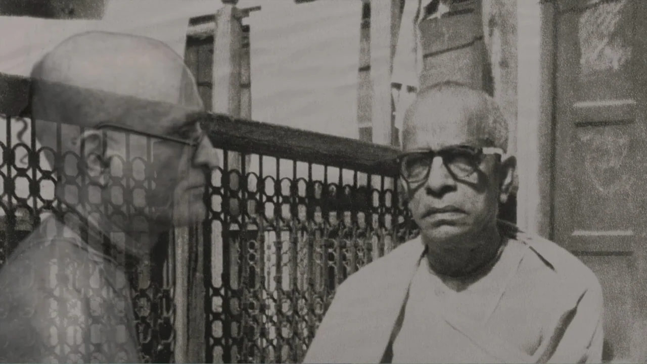 Hare Krishna! The Mantra, the Movement and the Swami Who Started It All (2017) movie still: medium — An outdoor stone balcony features an ornate…