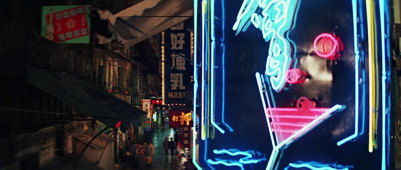 Indiana Jones and the Temple of Doom (1984) movie still: establishing — A narrow Hong Kong alleyway is crowded with illuminated neon signage and…