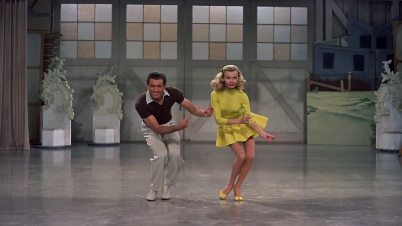 White Christmas (1954) movie still: fullbody — A spacious studio with a polished floor and decorative white filigree accents. A man and a woman…