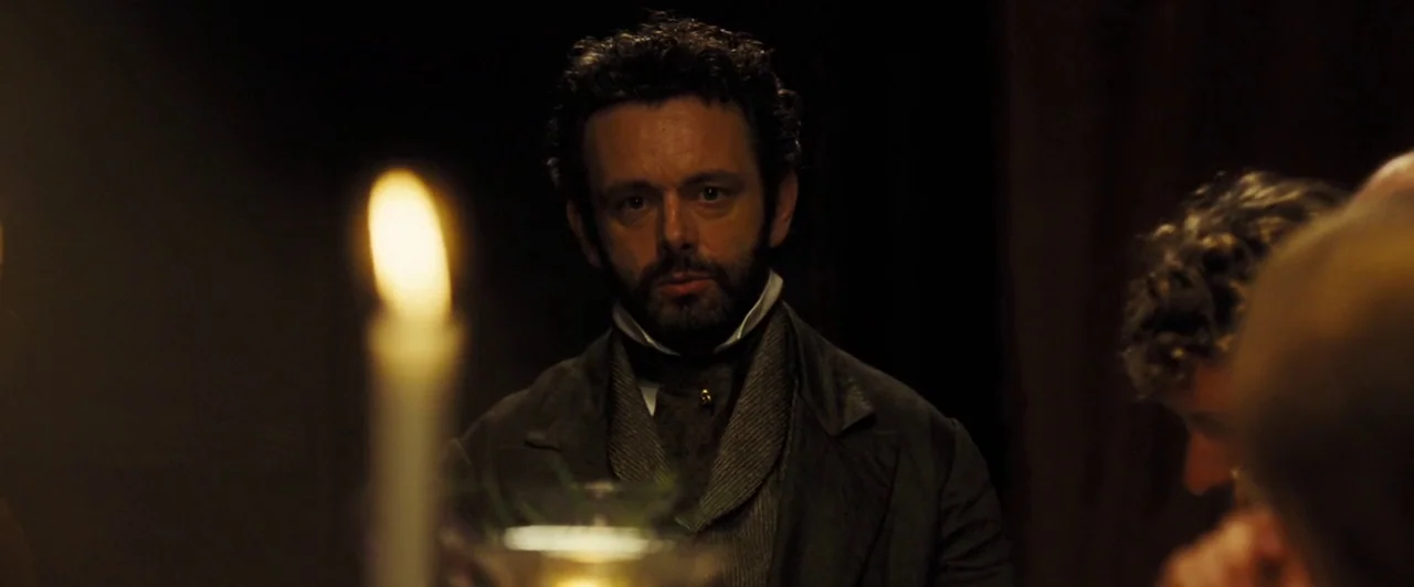 Far from the Madding Crowd (2015) movie still: medium — An dimly lit interior space with the soft warm glow of a nearby candle. A man in period…
