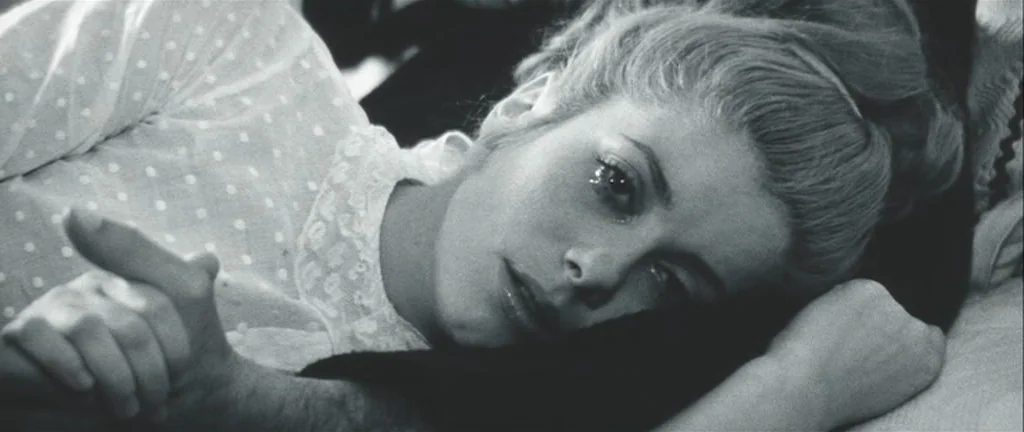 Les Créatures (1966) movie still: closeup — A woman rests her head on a dark pillow inside a domestic bedroom. The scene is presented in…