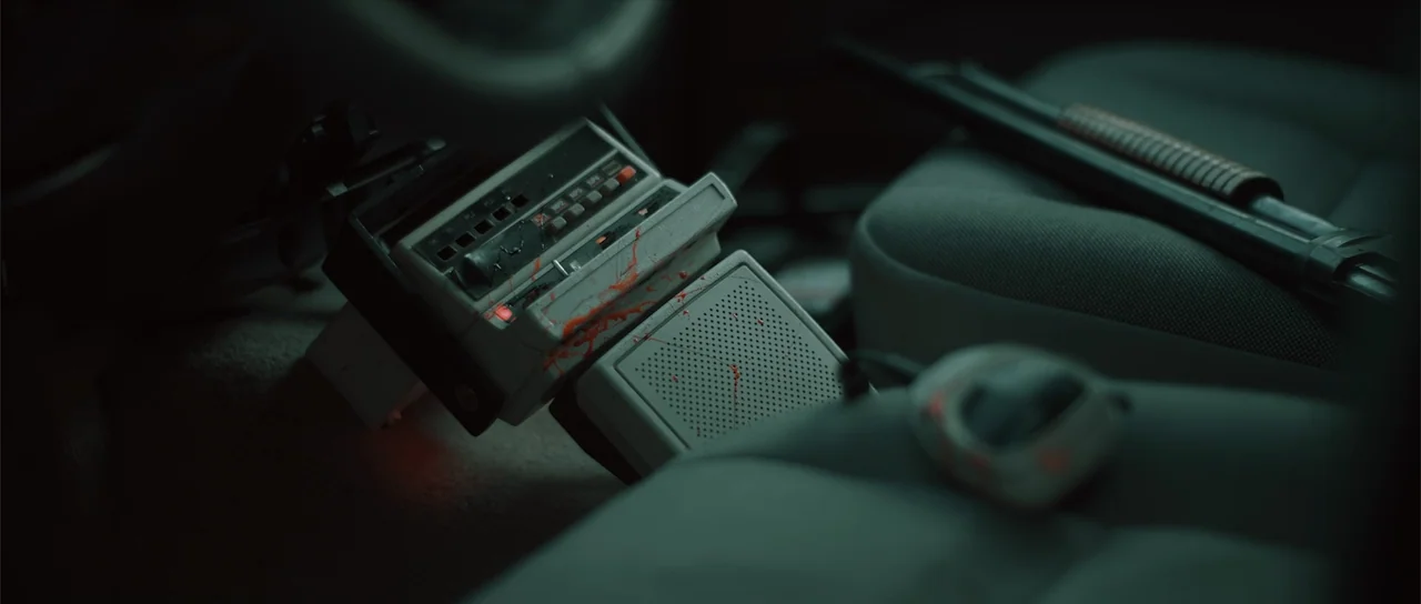 Night of the Missing (2023) movie still: closeup — The interior of a vehicle displays a console smeared with blood. A shotgun rests on the passenger…