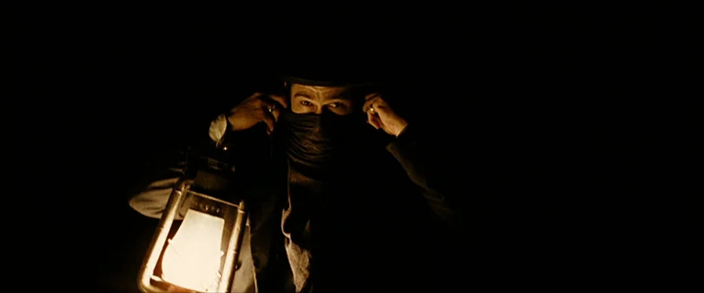 The Assassination Of Jesse James By The Coward Robert Ford (2007) movie still: closeup — A man stands in an environment of total blackness. He holds…