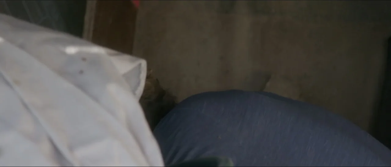 If You're Gone (2019) movie still: closeup — A close view of textile surfaces including a white cloth and blue garment. The background consists of a…