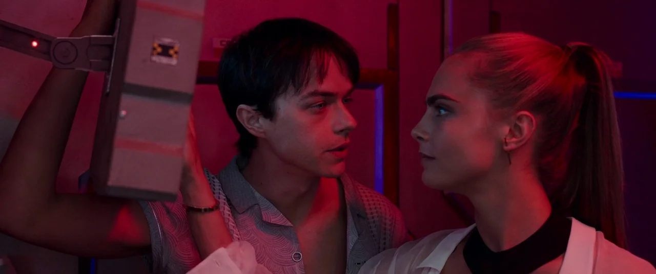 Valerian and the City of a Thousand Planets (2017) movie still: medium — A dimly lit room with technical equipment bathed in a deep red neon light.…