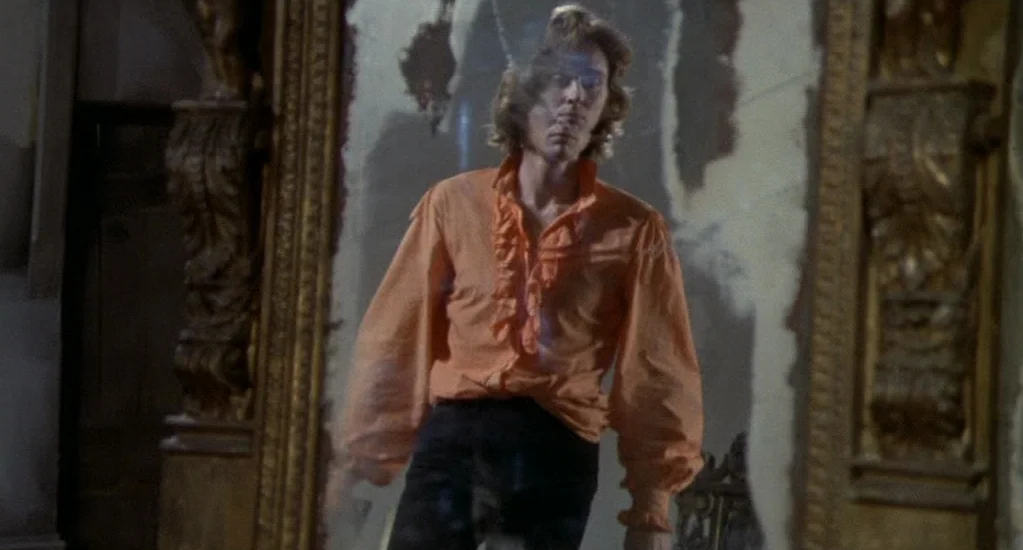 Demons of the Mind (1972) movie still: medium — A dimly lit passage features a large, ornate golden-framed mirror with weathered patches. A young…