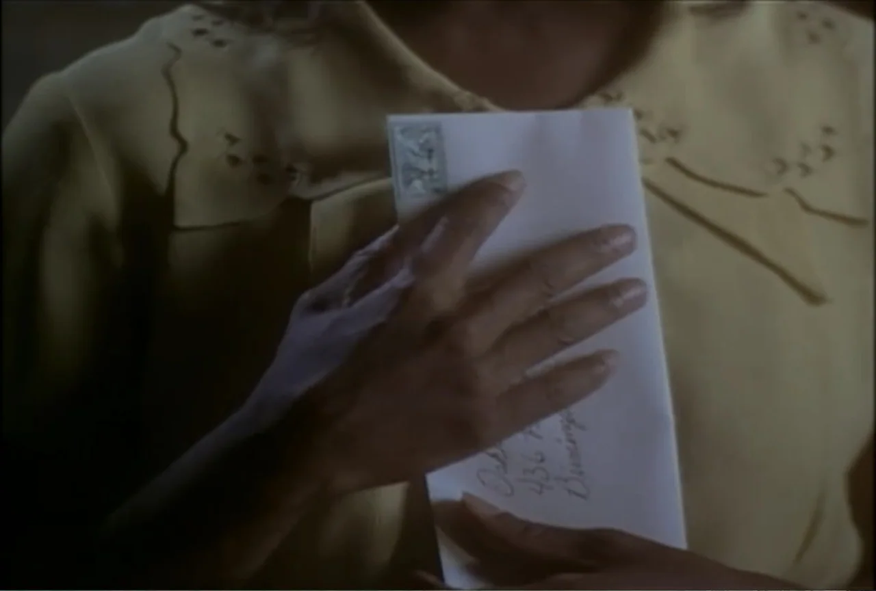 Miss Evers' Boys (1997) movie still: closeup — An interior shot focusing on the torso of a person in a yellow blouse. The person holds a white…