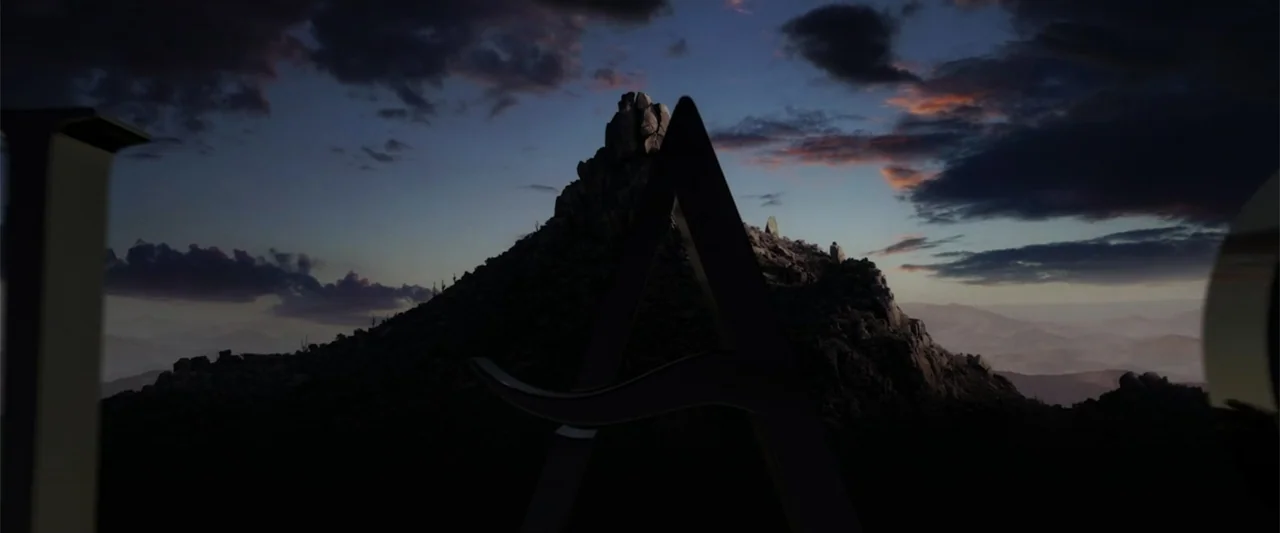 I Heard the Bells (2022) movie still: establishing — A dark rocky mountain silhouette stands against a twilight sky with scattered clouds. The…
