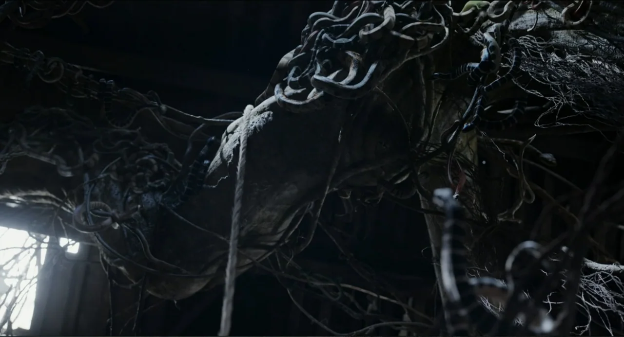 Legends of the Condor Heroes: The Gallants (2025) movie still: closeup — A dark, cramped interior space filled with old timber and thick layers of…