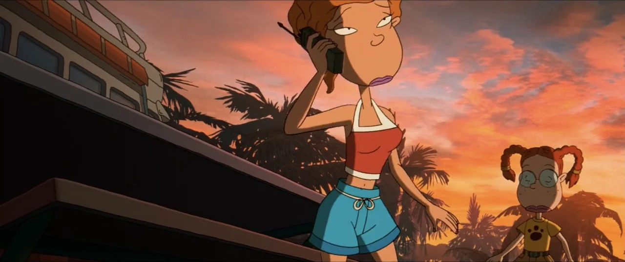 Rugrats Go Wild (2003) movie still: medium — A beach at sunset features stylized palm trees and a vehicle in the background. A woman in a red top…