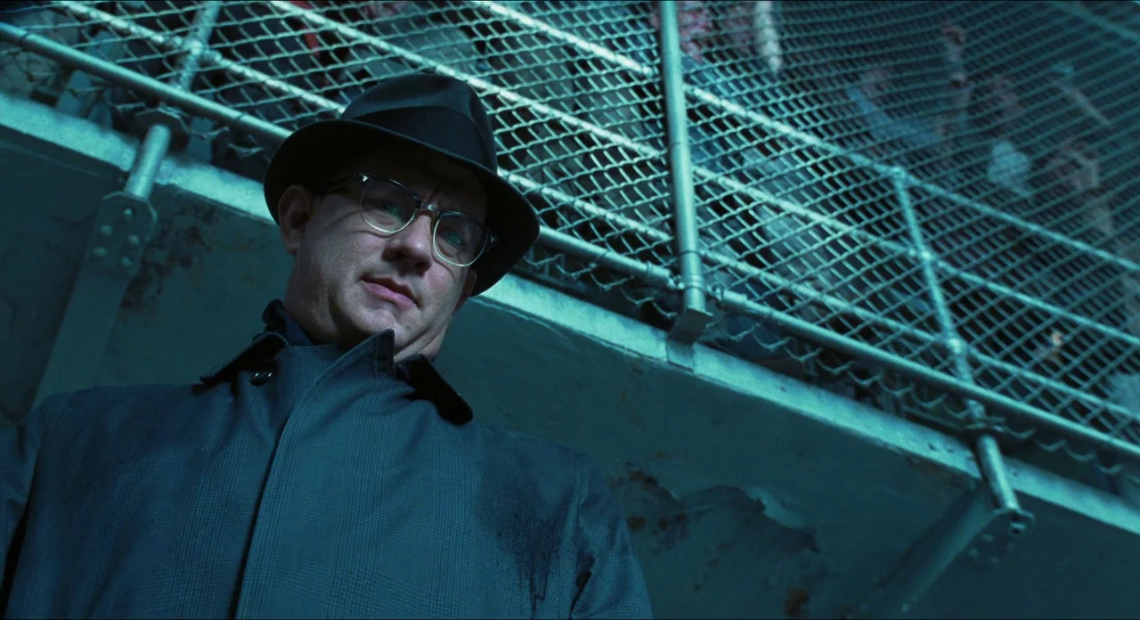 Catch Me If You Can (2002) movie still: medium — An exterior view of a ship deck featuring heavy metal grating under artificial light. A man in a…