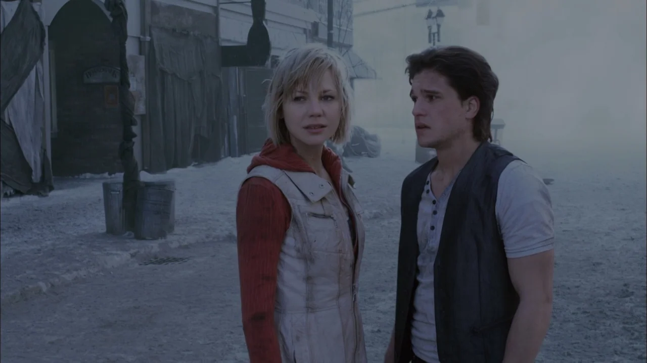 Silent Hill: Revelation 3D (2012) movie still: medium — A snowy, deserted town square features dark wooden buildings obscured by thick, lingering…