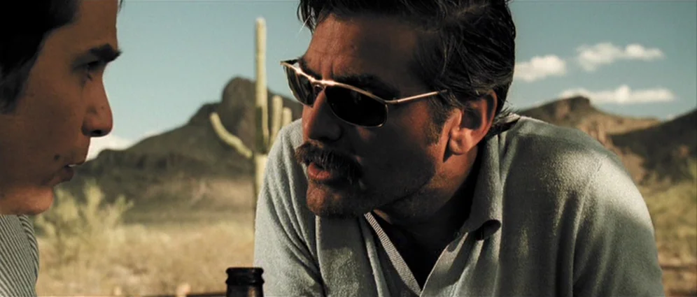 Confessions of a Dangerous Mind (2002) movie still: medium — An arid, sun-drenched desert landscape featuring a lone saguaro cactus against distant…
