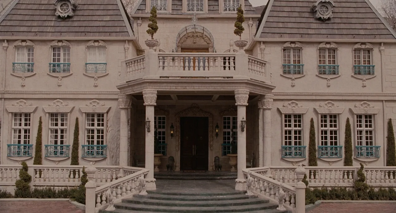Gentlemen Broncos (2009) movie still: establishing — A large symmetrical mansion features white stone walls and a dark shingled roof. A grand…