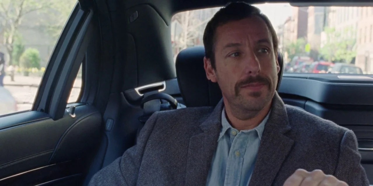 The Meyerowitz Stories (New and Selected) (2017) movie still: medium — A view inside the back seat of a car during the day. A man sits in the car…