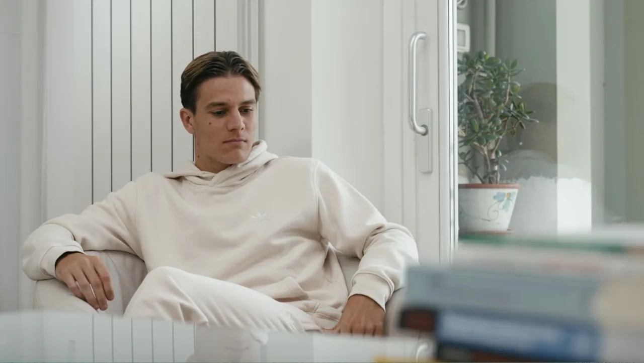 FRAGILE - The story of Nicolò Fagioli (2024) movie still: medium — A light-filled room features a white wall with a vertical radiator and a window.…